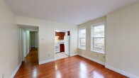 Located at 465 Zion St in Hartford, CT, this single-floor, 3-bedroom, 1-bathroom residence offers a well-organized and functional layout. Warm hardwood flooring flows throughout the main living areas and bedrooms, creating a cohesive and inviting atmosphere. The living room is a standout feature, boasting a curved bay window arrangement that floods the space with natural light and offers pleasant outdoor views. The kitchen is efficiently designed with rich, dark wood cabinetry, granite countertops, tile flooring, and white appliances including a range, dishwasher, and refrigerator. It connects conveniently to the living area through an open doorway. The three bedrooms are bright and comfortable, each featuring hardwood floors, natural light from double-hung windows, and baseboard heating. The primary bedroom includes a double-door closet for ample storage. Three additional closets throughout the unit provide generous storage options. The bathroom is clean and straightforward, complete with a full tub-shower combination. Hallways connect the rooms efficiently, and the entry features a solid front door opening to the main living space. Neutral wall tones throughout lend a fresh, move-in-ready feel to the entire home.