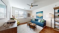 Located at 100 Shellbark Way in Savannah, Georgia, this single-story residence offers a thoughtfully designed layout with warm, cohesive interiors throughout. Rich hardwood-style flooring flows seamlessly across the main living areas, anchoring each room with a sense of warmth and continuity.

The living room is a welcoming focal point, featuring a ceiling fan with integrated lighting, wide windows fitted with horizontal blinds that invite ample natural light, and generous wall space ideal for artwork. The open layout connects effortlessly to both the dining area and kitchen.

The kitchen is bright and functional, showcasing white cabinetry, granite countertops, stainless steel appliances, and a peninsula island with pendant lighting and bar seating — perfect for casual dining or entertaining. Adjacent to the kitchen, the dining area provides an intimate setting with recessed lighting and stylish wall accents.

The primary bedroom is a serene retreat with hardwood-style flooring, a large window, and access to a well-sized bathroom complete with a soaking tub, tiled shower surround, dark granite vanity countertop, and white cabinetry. A walk-in closet provides generous storage. A second bedroom features plush carpet and a bright window overlooking the outdoors, offering a comfortable and private space.