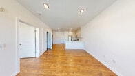 Located at 35 Spring St, Unit 302 in Wallington, NJ, this one-bedroom, one-bathroom residence offers a thoughtfully designed open-concept layout with clean, modern finishes throughout. Warm hardwood-style flooring flows seamlessly across the entire unit, complementing the bright white walls and recessed lighting that create a fresh, airy atmosphere.

The combined living and dining area provides a generous, flexible space ideal for both relaxing and entertaining. The well-appointed kitchen is a standout feature, showcasing tall white shaker-style cabinetry reaching to the ceiling for ample storage, a crisp white peninsula with an integrated sink, and a full suite of stainless steel appliances including a refrigerator, gas range, microwave, and dishwasher.

The spacious primary bedroom offers a comfortable retreat with access to multiple closets, including generously sized walk-in style closets with wire shelving systems to maximize organization. The bathroom is elegantly finished with a soaking tub framed by striking marble-style tile surround with subtle grey veining, lending a polished, upscale touch. An in-unit laundry area adds everyday convenience, rounding out this well-equipped and move-in-ready residence.