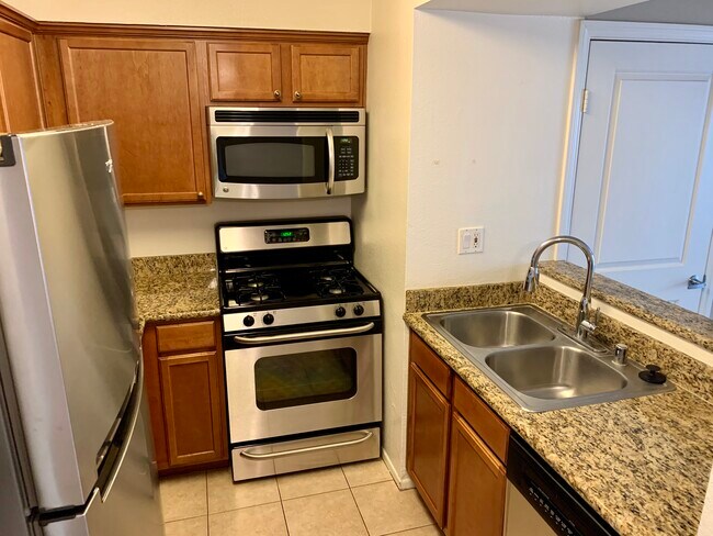 Kitchen open to living area - 355 N Maple St