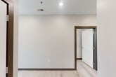 Located at 1601 Central Ave in Chattanooga, TN, this contemporary 2-bedroom, 2-bathroom unit offers a well-designed single-floor layout with a clean, modern aesthetic throughout. Light hardwood-style flooring and neutral-toned walls create a bright, cohesive atmosphere across every room.

The open-concept kitchen and living area serves as the heart of the unit, featuring sleek gray flat-front cabinetry, granite countertops, and a full suite of stainless steel appliances including a refrigerator, range, over-the-range microwave, and dishwasher. A large window brings in natural light and provides neighborhood views.

The generously sized primary bedroom offers ample space and is complemented by a dedicated bathroom. The second bedroom also benefits from natural light through large windows and includes a double-door closet for storage. Both bathrooms are finished with granite-top vanities, gray cabinetry, and light flooring that mirrors the rest of the unit.

Additional features include a dedicated laundry area, utility room, entrance foyer, and multiple hallways connecting each space efficiently. Recessed lighting and ceiling fans are present throughout, and dark wood door trim provides a refined contrast to the light interior palette.