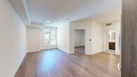 Located at 549 S Harvard Blvd in Los Angeles, this thoughtfully designed one-bedroom, one-bathroom unit offers a clean, modern aesthetic across its single floor. Warm wood-look flooring runs throughout, unifying the open-concept layout and complementing the bright, neutral walls.

The kitchen and living area share an open floor plan, making efficient use of the space. The kitchen is outfitted with a full suite of stainless steel appliances — including a gas range, over-the-range microwave, dishwasher, and French door refrigerator — set against two-tone cabinetry featuring white upper cabinets and wood-finish lower cabinets with matte black hardware. White quartz countertops and a classic subway tile backsplash with under-cabinet LED lighting complete the contemporary look.

The spacious bedroom features a sliding-door closet and a large window that brings in natural light and views of the surrounding urban environment. The living area offers a clean, flexible layout with recessed lighting overhead.

The bathroom is finished with tile flooring, a tiled tub-shower combination, a wall-mounted illuminated vanity mirror, and a wood-tone vanity with a stone-look countertop — all contributing to a crisp, modern feel. Throughout the unit, clean lines and a cohesive neutral palette create a calm, functional living environment.