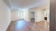 Located at 549 S Harvard Blvd in Los Angeles, this thoughtfully designed one-bedroom, one-bathroom unit offers a clean, modern aesthetic across its single floor. Warm wood-look flooring runs throughout, unifying the open-concept layout and complementing the bright, neutral walls.

The kitchen and living area share an open floor plan, making efficient use of the space. The kitchen is outfitted with a full suite of stainless steel appliances — including a gas range, over-the-range microwave, dishwasher, and French door refrigerator — set against two-tone cabinetry featuring white upper cabinets and wood-finish lower cabinets with matte black hardware. White quartz countertops and a classic subway tile backsplash with under-cabinet LED lighting complete the contemporary look.

The spacious bedroom features a sliding-door closet and a large window that brings in natural light and views of the surrounding urban environment. The living area offers a clean, flexible layout with recessed lighting overhead.

The bathroom is finished with tile flooring, a tiled tub-shower combination, a wall-mounted illuminated vanity mirror, and a wood-tone vanity with a stone-look countertop — all contributing to a crisp, modern feel. Throughout the unit, clean lines and a cohesive neutral palette create a calm, functional living environment.