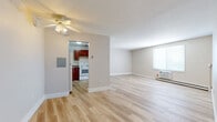 Located at 6871 Ames Rd in Parma, Ohio, this single-floor, 3-bedroom, 1-bathroom unit offers a well-organized and functional layout throughout. Light wood-style flooring runs consistently across the space, creating a clean, cohesive aesthetic in every room. The living room is generously sized, featuring a ceiling fan with light fixture, neutral-toned walls, and a window unit air conditioner alongside baseboard heating, ensuring year-round comfort. An open passageway connects the living area to the kitchen, which is equipped with rich cherry wood cabinetry, granite-style countertops, a stainless steel sink, and white appliances including a refrigerator, dishwasher, and electric range. The three bedrooms are well-proportioned, each benefiting from natural light through sizable windows with blinds and individual baseboard heaters. The primary bedroom offers a spacious footprint with ample room for furnishings. Three closets throughout the unit provide practical storage, including wire-shelved closets for organized use. The full bathroom features a warm wood vanity with an integrated sink, a medicine cabinet mirror, and accessibility-friendly grab bars. Overall, the unit presents a clean, move-in-ready environment with a neutral palette and consistent finishes throughout.