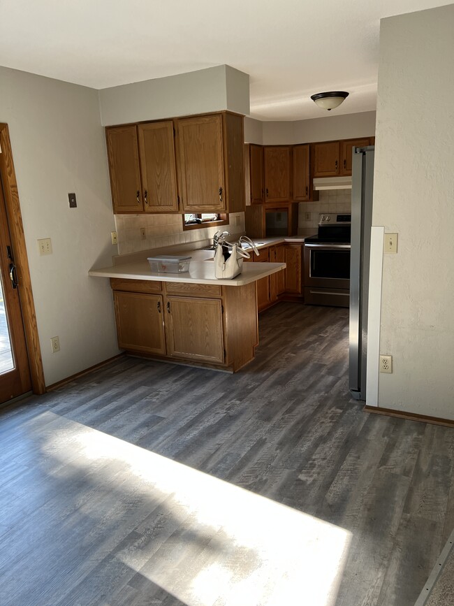 New plank flooring in living room and dining area - 706 10th St S