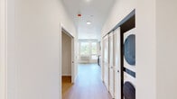 Located at 2463 Hogum Bay Rd NE in Lacey, WA, this well-designed one-bedroom, one-bathroom unit offers a thoughtfully organized layout across a single floor. The open living and kitchen area is bathed in natural light from a trio of large windows that frame views of the surrounding tree canopy and neighborhood, creating a bright and welcoming atmosphere throughout. Light wood-tone flooring runs seamlessly through the space, complementing the neutral, warm wall tones.

The kitchen is efficiently designed with full-height cabinetry in a contemporary taupe finish, offering ample storage. A complete suite of stainless steel appliances — including a gas range, dishwasher, and refrigerator — pairs with clean white countertops and a stainless sink to deliver both functionality and a modern aesthetic.

The bedroom is a comfortable, quiet retreat with its own closet featuring sliding louvered doors, and continues the same warm wood flooring found throughout. The bathroom is clean and functional, featuring a full soaking tub with shower, a vanity with cabinetry, and light wood-tone flooring that ties the space together. A wall-mounted HVAC unit ensures personalized climate control. The overall ambiance is clean, modern, and move-in ready.