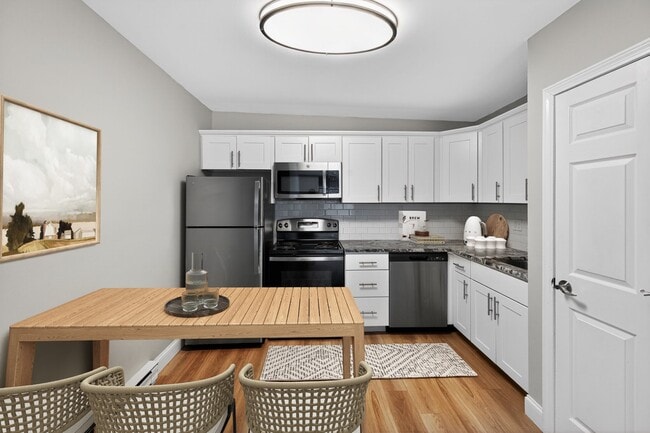 Elevate your living at Eagle Rock Apartments at Hudson, featuring modern kitchens with sleek appliances and stylish finishes. Enjoy the comfort and convenience of a spacious dining area. Schedule your tour today to see your new home! - Eagle Rock Apartments at Hudson