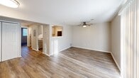 Located at 2723 S Topeka St in Wichita, Kansas, this one-bedroom, one-bathroom unit offers a practical and well-appointed single-floor layout. The living room serves as the heart of the space, featuring wood-style plank flooring, neutral walls, a ceiling fan with light fixture, and a sliding glass door framed by vertical blinds that allows natural light to filter in. An open pass-through connects the living area to the kitchen, which is outfitted with cabinetry and stone-look countertops, creating a functional and connected layout. The bedroom is a comfortable, carpeted retreat equipped with its own ceiling fan, a window with horizontal blinds for natural light and privacy, and a double-door closet offering ample storage. The bathroom includes a full-size soaking tub with an overhead shower, a built-in niche for storage, and clean white surrounds with chrome fixtures. Consistent neutral tones and clean finishes throughout the unit create a cohesive, move-in-ready atmosphere. The straightforward single-floor plan makes efficient use of the available space, providing all essential amenities in a compact and functional arrangement.