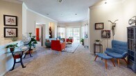 Located at 8610 N Kansas Ave in Kansas City, MO, this single-floor residence offers 2 bedrooms, 2 bathrooms, and a thoughtfully designed layout that maximizes comfort and functionality. The open-concept living and dining area is the heart of the home, featuring plush carpet, crown molding, and an abundance of natural light streaming through large windows and a sliding glass door that opens to an outdoor view. The spacious living room provides ample room for comfortable seating arrangements. The kitchen is equipped with light wood cabinetry, granite-style countertops, stainless steel appliances including a range and built-in microwave, and tile flooring, offering both style and practicality. The primary bedroom is generously sized with carpeted flooring and access to a walk-in closet fitted with wire shelving. The second bedroom also features carpet and a large window. Both bathrooms include light wood vanities with white countertops and tile flooring; one features a full tub-shower combination. Additional highlights include three closets for storage, a dedicated laundry area, and a utility room, rounding out a complete and well-organized living space.