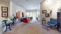 Located at 8610 N Kansas Ave in Kansas City, MO, this single-floor residence offers 2 bedrooms, 2 bathrooms, and a thoughtfully designed layout that maximizes comfort and functionality. The open-concept living and dining area is the heart of the home, featuring plush carpet, crown molding, and an abundance of natural light streaming through large windows and a sliding glass door that opens to an outdoor view. The spacious living room provides ample room for comfortable seating arrangements. The kitchen is equipped with light wood cabinetry, granite-style countertops, stainless steel appliances including a range and built-in microwave, and tile flooring, offering both style and practicality. The primary bedroom is generously sized with carpeted flooring and access to a walk-in closet fitted with wire shelving. The second bedroom also features carpet and a large window. Both bathrooms include light wood vanities with white countertops and tile flooring; one features a full tub-shower combination. Additional highlights include three closets for storage, a dedicated laundry area, and a utility room, rounding out a complete and well-organized living space.