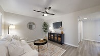 Located in Mesa, Arizona, this well-appointed single-story home offers a smart and functional layout across one level, featuring one bedroom, two bathrooms, dual living areas, a dedicated office, a dining room, and a fully updated kitchen. Light gray walls and wood-look flooring flow consistently throughout, creating a cohesive and contemporary aesthetic. The two living areas are bright and airy, each equipped with a ceiling fan and natural light from large windows with blinds. The kitchen stands out with crisp white cabinetry, quartz countertops, a subway tile backsplash, and stainless steel appliances, including a dishwasher, range, and over-the-range microwave. The dining area is positioned adjacent to a sliding glass door, allowing natural light to fill the space. The generously sized primary bedroom features direct access to one of the two bathrooms, which includes a walk-in shower with clean white tile surround. A second bathroom provides additional convenience. The dedicated office is a versatile space with its own window and ceiling fan, ideal for remote work or as a flex room. A hallway connects the spaces efficiently, and a closet provides practical storage. The overall ambiance is clean, modern, and inviting throughout.