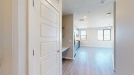 Located at 123 E Corporate Pl in Chandler, AZ, this well-designed one-bedroom, one-bathroom unit offers a thoughtful layout across a single floor. Light wood-look flooring flows consistently throughout the space, creating a bright and cohesive aesthetic.

The kitchen is a standout feature, showcasing a two-tone cabinet design with soft blue-gray lower cabinets and crisp white upper cabinets. A full suite of stainless steel appliances includes a French door refrigerator, gas range, over-the-range microwave, and dishwasher. Light quartz countertops and a white tile backsplash complete the clean, modern look. A window alongside the kitchen brings in natural light and views of the surrounding area.

The bedroom is a comfortable, well-proportioned room featuring a ceiling fan, a large window with outdoor views, and light-toned walls that enhance the airy feel. A dedicated closet provides convenient storage.

The bathroom features large-format stone-look tile in the shower/tub surround, paired with a gray vanity, white countertop, and wood-look flooring that ties the space together. Recessed lighting and clean white walls give the unit a fresh, move-in-ready appearance throughout. A built-in shelving nook near the entry adds practical storage.