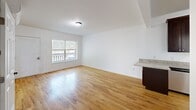 Located at 48 High St in Bristol, CT, this 2-bedroom, 1-bathroom unit offers a well-designed single-floor layout that makes efficient use of its space. Warm hardwood flooring flows throughout the living areas and bedrooms, lending a cohesive and inviting feel to the home.

The kitchen is a standout feature, equipped with rich dark wood cabinetry, granite countertops, and a full suite of stainless steel appliances including a refrigerator, electric range, built-in microwave, and dishwasher. The open connection to the living area creates a natural flow for everyday living and entertaining.

The living room is bright and airy, benefiting from a large window that overlooks an outdoor deck, filling the space with natural light. Both bedrooms continue the hardwood flooring and feature clean white walls with six-panel doors. The primary bedroom offers generous proportions and a closet, while the second bedroom also includes a closet and a window with outdoor views.

The bathroom is clean and functional, featuring tile flooring, a walk-in shower with grab bars, and a straightforward, no-fuss design. A stacked washer and dryer unit is also included within the home, adding everyday convenience.