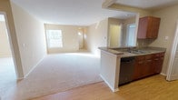 This single-floor, 3-bedroom, 2-bathroom home features a practical and well-organized layout designed to maximize everyday comfort. The open living and dining area is finished with plush carpeting and neutral beige walls, creating a bright and welcoming atmosphere enhanced by natural light from several windows that offer views of surrounding greenery. The space flows seamlessly into the kitchen, which is separated by a peninsula counter topped with granite-style surfaces. The kitchen is equipped with stainless steel appliances, including a gas range, refrigerator, and dishwasher, alongside warm wood-toned cabinetry and hardwood-style flooring that adds contrast to the neutral palette.

Each of the three bedrooms is carpeted and finished with the same warm neutral tones found throughout the home, offering a calm and versatile setting. Two bedrooms feature windows with natural views, while the primary bedroom includes direct access to a private bathroom. Both bathrooms are outfitted with granite-topped vanities, wood-toned cabinetry, and tiled tub-shower combinations, providing a clean and consistent design. The overall ambiance of the home is light, functional, and move-in ready.