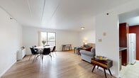 Located at 224 S Burrowes St in State College, PA, this two-bedroom, one-bathroom residence offers a practical and comfortable single-floor layout. The open living and dining area is a standout feature, with light wood-style flooring, bright white walls, and a large sliding glass door that floods the space with natural light and provides access to an outdoor balcony with views of the surrounding neighborhood. The living area accommodates a sectional seating arrangement alongside a dedicated dining space, creating a versatile and welcoming environment.

The kitchen is well-appointed with warm wood cabinetry, granite-style countertops, a bold accent wall, and a full suite of appliances including a refrigerator, range, and dishwasher, all set on clean tile flooring. The primary bedroom is generously sized, featuring plush carpeting and ample built-in closet storage with double wardrobe-style doors. The second bedroom also features carpeted flooring, natural window light, and comfortable proportions. Three closets throughout the unit provide abundant storage. The shared bathroom includes tile flooring, tile wainscoting, a combined tub and shower with a sliding glass door, and a wood-cabinet vanity. A connecting hallway ties the layout together efficiently.