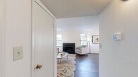 Located at 175 North Mount Tabor Road in Lexington, Kentucky, this single-story home offers a practical and comfortable layout across a well-utilized floor plan. The inviting living room serves as the heart of the home, featuring a sleek black fireplace flanked by windows that bring in natural light and hardwood-style flooring that runs throughout the main living areas. The adjacent dining room is brightened by a pendant light overhead and a sliding glass door that opens to an outdoor view, creating a seamless connection between interior and exterior. The galley-style kitchen is well-equipped with dark cabinetry, granite-style countertops, a stainless steel sink, and black appliances, all complemented by a window above the counter. The spacious primary bedroom features plush carpeting, a walk-in closet, and direct access to a private en-suite bathroom with a glass-enclosed shower. A versatile office with its own closet and carpet flooring provides an ideal space for work or study. Two full bathrooms serve the home with functional finishes. A dedicated laundry room with full-size washer and dryer hookups adds everyday convenience. The home's clean, bright aesthetic and thoughtful room variety make it a highly functional and comfortable residence.