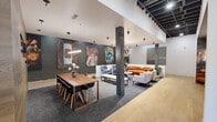 Located at 2500 Ohio Ave in Saint Louis, MO, this thoughtfully designed single-floor space offers a generous and open layout that blends contemporary aesthetics with artistic character. The space is anchored by a well-appointed living area featuring a mix of plush orange curved sofas, neutral lounge chairs, and a sculptural marble-top coffee table, all set atop a patterned area rug over light hardwood flooring. A striking geometric chandelier with exposed Edison-style bulbs serves as a dramatic focal point overhead.

One of the most distinctive design elements is a bold, dark-toned botanical and marine-life wallcovering that lines a dedicated lounge nook, adding warmth and visual depth to the space. Additional seating in rich amber tones is tucked into this intimate alcove, creating a cozy retreat within the larger open floor plan.

The entrance area features clean white walls, light wood flooring, and a circular black pedestal table beneath another sculptural chandelier, complemented by bold contemporary artwork and lush potted plants. Further into the space, exposed painted brick walls, dark ceiling structural elements, and wood-clad columns add an industrial-chic character. Curated large-scale art pieces line the walls, contributing to the gallery-like atmosphere. The overall ambiance is vibrant, design-forward, and welcoming.