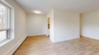 Located at 274-278 Cedar Ave in Richmond Hill, Ontario, this 1-bedroom, 1-bathroom unit offers a thoughtfully designed layout across a single floor. Light-toned laminate hardwood flooring runs throughout, creating a cohesive and clean aesthetic in every room.

The spacious living area is bright and airy, featuring large windows that frame views of the surrounding greenery, allowing abundant natural light to fill the space. Baseboard heating is present throughout, ensuring year-round comfort.

The galley-style kitchen is a functional highlight, outfitted with white shaker cabinetry, dark countertops, a subway tile backsplash, and a full suite of stainless steel appliances including a refrigerator, stove, and microwave. A stainless steel sink completes the well-equipped setup.

The bedroom is a comfortable, quiet retreat with a window overlooking the outdoors and a built-in sliding door closet providing ample storage. The clean white walls and light flooring contribute to a calm, restful atmosphere.

The bathroom features a full soaker tub and shower combination, fully clad in crisp white subway tiles with chrome fixtures, lending a fresh, modern feel. The overall design of this unit is clean, neutral, and move-in ready, making it an ideal home in a well-connected Richmond Hill location.