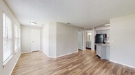 Located at 675 Jamestown Blvd in Altamonte Springs, FL, this well-appointed one-bedroom, one-bathroom unit offers a thoughtfully organized single-level layout. Wood-look flooring runs throughout the space, complementing the neutral, light-toned walls and textured ceilings that give each room a clean, consistent aesthetic.

The open living room is generously sized, bathed in natural light through multiple windows fitted with horizontal blinds, and features a ceiling fan for added comfort. The space flows naturally into the combined kitchen and living area, making it ideal for everyday living.

The kitchen is a standout feature, showcasing gray shaker-style cabinetry, granite-look countertops, a white subway tile backsplash, and black appliances including a refrigerator and electric range. A single-basin sink adds functionality, and a doorway leads conveniently to the in-unit laundry area.

The bedroom is a comfortable size, with a window that brings in natural light and views of surrounding greenery. A dedicated closet provides practical storage. The bathroom is neatly finished with a granite-topped vanity with gray cabinetry, a full tub-shower combo with white tile surround, and wood-look flooring that ties the space together cohesively.