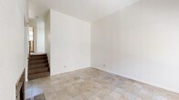 Located at 4763 Appian Way in El Sobrante, California, this multi-level 2-bedroom, 2-bathroom unit spans three floors, offering a well-organized layout with distinct living spaces on each level. The entry-level living room makes a strong first impression with soaring ceilings, a large picture window that draws in natural light and garden views, and a granite-surround fireplace that anchors the room as a cozy focal point. Tile flooring runs consistently throughout the home, lending a clean, cohesive aesthetic. The kitchen is thoughtfully appointed with warm maple cabinetry, dark granite countertops, a full suite of white appliances, and a sliding glass door that opens to an outdoor area, enhancing the sense of connection to the exterior. Both bathrooms carry the same granite countertop detailing, paired with maple vanity cabinetry and mirrored medicine cabinets. The two bedrooms are generously proportioned, each featuring double closets for ample storage and windows that provide natural light and views of the surrounding neighborhood. The spacious primary bedroom occupies a significant portion of the upper floor. Baseboard heating is present throughout, ensuring year-round comfort. The overall ambiance is bright, functional, and consistent in its modern-yet-approachable finishes.