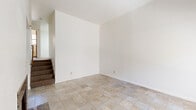 Located at 4763 Appian Way in El Sobrante, California, this multi-level 2-bedroom, 2-bathroom unit spans three floors, offering a well-organized layout with distinct living spaces on each level. The entry-level living room makes a strong first impression with soaring ceilings, a large picture window that draws in natural light and garden views, and a granite-surround fireplace that anchors the room as a cozy focal point. Tile flooring runs consistently throughout the home, lending a clean, cohesive aesthetic. The kitchen is thoughtfully appointed with warm maple cabinetry, dark granite countertops, a full suite of white appliances, and a sliding glass door that opens to an outdoor area, enhancing the sense of connection to the exterior. Both bathrooms carry the same granite countertop detailing, paired with maple vanity cabinetry and mirrored medicine cabinets. The two bedrooms are generously proportioned, each featuring double closets for ample storage and windows that provide natural light and views of the surrounding neighborhood. The spacious primary bedroom occupies a significant portion of the upper floor. Baseboard heating is present throughout, ensuring year-round comfort. The overall ambiance is bright, functional, and consistent in its modern-yet-approachable finishes.