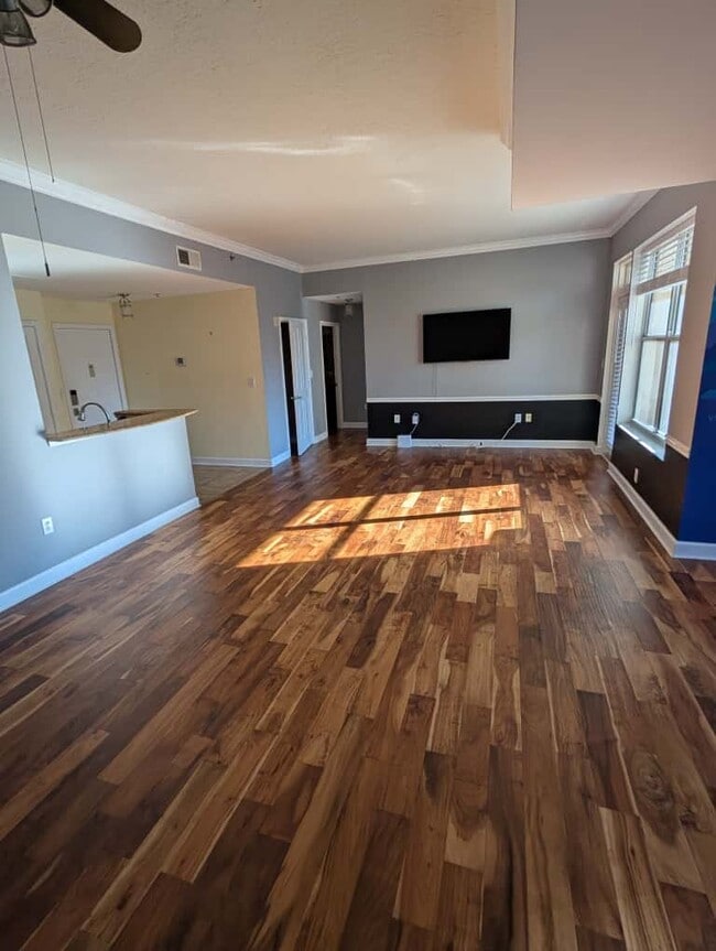 Living room with den/dining area, brand-new blinds, and included wall-mounted Smart TV - 1101 Juniper St NE Apartment