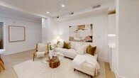 Located in the sought-after Kalorama neighborhood of Washington, DC, this one-bedroom, one-bathroom residence offers a thoughtfully designed open layout with a clean, modern aesthetic throughout. The living and dining area flows seamlessly, bathed in natural light from large windows and complemented by recessed lighting, crisp white walls, and light wood flooring that runs throughout the space. The living area provides a comfortable setting, while the adjacent dining nook offers an intimate spot for meals. The galley-style kitchen is outfitted with sleek white cabinetry, under-cabinet lighting, white quartz countertops, and modern integrated appliances, maximizing both style and efficiency. The bedroom features two windows that frame views of the surrounding neighborhood, a spacious double sliding-door closet, and ample room for a full workspace. An additional closet provides extra storage. The bathroom is a standout, showcasing warm wood-toned cabinetry, a floating vanity with an LED-backlit mirror, and a glass-enclosed walk-in shower with floor-to-ceiling tile. Two closets further enhance the unit's storage capacity. The overall ambiance is light, airy, and refined, making this Kalorama residence a well-appointed urban retreat.
