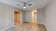 This two-story residence offers a thoughtfully designed layout spread across two levels, connected by a central staircase visible in the floor plan. The kitchen is a functional highlight, featuring warm honey-toned cabinetry, granite countertops, a classic subway tile backsplash, and stainless steel appliances including a refrigerator, electric range, and dishwasher. A dedicated dining area adjacent to the kitchen benefits from natural light through a large window. The living areas on the main floor are finished with light hardwood-style flooring and neutral-toned walls, creating a bright, open feel. Ceiling fans are present throughout, providing both lighting and ventilation. The upper level houses the bedrooms, each carpeted and finished with the same neutral palette. Multiple windows allow natural light to filter in, offering views of surrounding greenery. The bathrooms feature tile flooring and clean, minimal finishes. Textured ceilings are consistent throughout the home, adding subtle architectural character. Overall, the space presents a practical and comfortable layout suitable for everyday living.