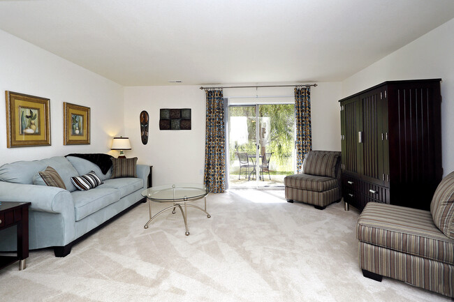 Spacious living room connected to the dining area. - Shadowmoss Pointe Apartments and Townhomes