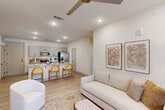 Located at 8340 Picardy Ave in Baton Rouge, LA, this well-appointed 2-bedroom, 2-bathroom residence offers a thoughtfully designed single-level layout with a bright, neutral palette throughout. The open-concept living, dining, and kitchen area serves as the heart of the home, anchored by a granite-topped island with bar seating — ideal for casual dining or entertaining. The kitchen features gray shaker-style cabinetry with matte black hardware, a classic white tile backsplash, and a full suite of stainless steel appliances. Light wood-look flooring flows seamlessly throughout the space, enhancing the airy feel. The living area is bathed in natural light and opens directly to a private outdoor balcony through elegant French doors, while a ceiling fan adds comfort overhead. The primary bedroom is generously sized, featuring a ceiling fan, large windows with outdoor views, and access to a well-appointed bathroom with granite countertops, gray cabinetry, and a tub-shower combination. Five closets are distributed throughout the unit, ensuring abundant storage. A dedicated laundry area adds everyday convenience. The overall ambiance is clean, contemporary, and welcoming — a comfortable retreat in a prime Baton Rouge location.