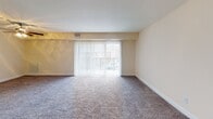 Located at 3333 Hewitt Ave in Silver Spring, Maryland, this single-floor residence offers a well-organized layout designed for comfortable everyday living. The spacious living room is finished with plush carpeting and features large sliding glass doors fitted with vertical blinds, allowing generous natural light and outdoor views. The entry foyer transitions smoothly into the main living area, creating an open and welcoming atmosphere throughout.

The kitchen is a standout feature, showcasing dark espresso cabinetry, granite-style countertops, and black appliances including a refrigerator, gas range, and built-in microwave. A peninsula counter with an overhang connects the kitchen to the living space, making it ideal for casual dining or entertaining.

The residence includes two well-proportioned bedrooms, each carpeted and brightened by windows with vertical blinds. One bedroom features a sliding closet with built-in shelving, providing ample storage. Two bathrooms serve the unit — one equipped with a soaking tub and tiled surround, the other with a standalone glass-enclosed shower — both featuring wood-look flooring, dark vanity cabinetry, and granite-style countertops. Clean white walls and consistent finishes throughout lend the space a cohesive, move-in ready appeal.