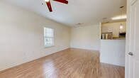 This single-story, one-bedroom, one-bathroom residence in Savannah, Georgia offers a thoughtfully designed layout that maximizes its compact footprint. Throughout the unit, light-toned hardwood-style flooring provides a cohesive and clean aesthetic, complemented by neutral cream-colored walls that enhance the sense of openness.

The living room serves as the central gathering space, benefiting from a ceiling fan and track lighting, along with a window that draws in natural light and outdoor views. It connects openly to the kitchen, which is well-equipped with stainless steel appliances—including a refrigerator, range, and dishwasher—white shaker-style cabinetry, granite countertops, and a deep undermount sink, all contributing to a functional and polished cooking environment.

The bedroom is a comfortable, well-proportioned space featuring a ceiling fan, a window with outdoor views, and a closet. The bathroom maintains the same consistent finishes found throughout, offering a vanity with granite countertops and shaker-style cabinetry, a mirror, and a full soaking tub with shower. Clean lines and neutral tones give the bathroom a tidy, practical character. Overall, the unit presents a cohesive, modern interior well-suited for efficient single-floor living.