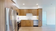 Located at 900 Chestnut St in Redwood City, CA, this thoughtfully designed 2-bedroom, 1-bathroom unit offers a clean, modern aesthetic throughout its single-floor layout. Light-toned hardwood flooring runs seamlessly across every room, creating a cohesive and airy feel.

The kitchen is a standout feature, outfitted with warm wood cabinetry extending to the ceiling for ample storage, a white countertop with an under-mount sink, and a full suite of stainless steel appliances including a refrigerator, range, microwave, and dishwasher. Recessed lighting illuminates the space efficiently.

Both bedrooms are finished in crisp white walls and share the same warm hardwood flooring. The primary bedroom includes a sliding-door closet for convenient storage. Each bedroom benefits from natural light through large windows that offer views of the surrounding Redwood City neighborhood. The second bedroom features a particularly expansive window, flooding the room with daylight.

The bathroom maintains the modern design language with a wood-toned vanity cabinet, white countertop, a large mirror, and light-colored flooring that ties the space together.

Overall, this unit presents a bright, clean, and contemporary living environment well-suited to those seeking a functional and stylish home in the heart of Redwood City.