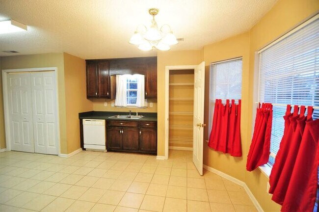 Building Photo - Comfortable with nearly an acre fenced yard.