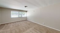Located at 301 Woodlawn Pike in Knoxville, Tennessee, this single-story, two-bedroom, two-bathroom home offers a straightforward and functional layout connected by a central hallway. The floor plan makes efficient use of its space, with each room clearly defined and accessible.

Both bedrooms feature neutral gray walls, wall-to-wall carpet, and white trim throughout. The primary bedroom is a generously sized room with dual closet doors — one a sliding panel closet and the other a standard hinged door — providing ample storage. A window allows in natural light with views of the surrounding greenery. The second bedroom is similarly finished with carpet, neutral tones, and its own sliding panel closet, along with a window offering outdoor views.

The bathrooms are clean and practical. One bathroom includes a full tub-shower combo with a white surround and chrome fixtures. The other bathroom features wood-look plank flooring, a wide vanity with white cabinetry, a light-colored countertop, a large mirror, and tile accent detailing, opening into the hallway for easy access from both bedrooms.

The living area benefits from a wide bank of windows that flood the space with natural light. The overall aesthetic is clean and neutral, making this home a versatile and move-in-ready option in the Knoxville area.