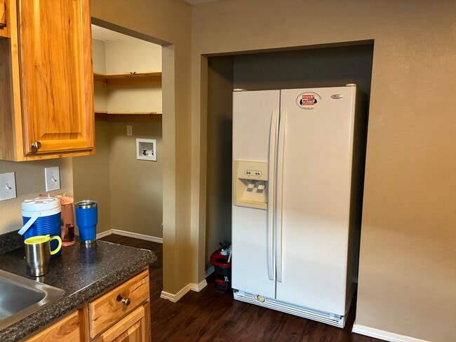Kitchen Fridge and View of Laundry Room - 1109 Cedar Dr