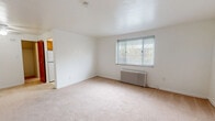Located at 450 Jefferson Ave in Bellevue, PA, this one-bedroom, one-bathroom unit offers a practical and comfortable single-floor layout. The generously sized bedroom is the centerpiece of the home, featuring soft wall-to-wall carpeting, bright white walls, and a classic cast-iron radiator that provides efficient heating. A window fitted with blinds allows natural light to filter in while maintaining privacy. A ceiling fan adds to the room's comfort year-round. Adjacent to the bedroom is a dedicated walk-in closet outfitted with built-in shelving and hanging rods, offering ample storage space. The kitchen is equipped with warm-toned wood cabinetry extending to the upper and lower sections, a white refrigerator, and a single-basin stainless steel sink set into a light countertop — providing a functional and organized cooking space. The bathroom features a full-size bathtub with tiled surround and a window that brings in natural light and ventilation, keeping the space bright and airy. The unit's clean, neutral palette and efficient floor plan make it a straightforward and functional living space in the Bellevue community.