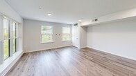 Located at 938 E Fourth St in Bethlehem, PA, this well-appointed 2-bedroom, 1-bathroom unit offers a thoughtfully designed single-floor layout across a comfortable footprint. The open-concept living and dining area welcomes natural light through large windows with views of the surrounding neighborhood, all set atop warm, light-toned hardwood-style flooring. The kitchen serves as the heart of the space, showcasing a granite-topped island with an undermount sink, gray shaker cabinetry, a marble-style tile backsplash, and a full suite of stainless steel appliances including a gas range, microwave, and refrigerator. Both bedrooms feature plush carpeting and generous windows that frame lush tree views, filling each room with natural light. The primary bedroom offers a notably spacious feel with ample closet space. The bathroom is clean and contemporary, with a white vanity, geometric-patterned tile flooring, and bright overhead lighting. Additional highlights include a dedicated laundry area, five closets throughout for excellent storage, and a hallway that efficiently connects all rooms. Recessed lighting throughout the living areas and kitchen adds a polished, modern touch to this move-in-ready Bethlehem residence.