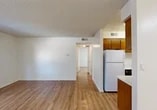 Located at 7007 Inglewood Ave in Stockton, California, this single-floor unit presents a clean and functional layout designed for comfortable everyday living. The open living area features light wood-style flooring that extends throughout the space, crisp white walls, and a textured ceiling that adds subtle character. Natural light flows generously through large sliding glass doors that lead to a private outdoor patio, offering views of the surrounding neighborhood greenery and a seamless indoor-outdoor connection.

The kitchen is efficiently arranged with white cabinetry, ample counter space, a built-in electric range, an under-cabinet range hood, and a dishwasher. A window above the counter brings in natural light, keeping the workspace bright and airy. A full-size refrigerator is also included.

The bedroom is a well-proportioned, sunlit room with the same wood-style flooring and a wall-mounted air conditioning unit for year-round comfort. The bathroom is outfitted with a tub-shower combination featuring marble-style surround panels, a vanity with a light stone countertop, and a large mirror. Additional rooms provide flexible living or storage options. The exterior of the building features a neutral stucco finish with a pitched shingle roof and maintained landscaping.