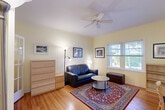 Located at 903 Seventh St in Santa Monica, CA, this efficient one-bedroom, one-bathroom unit offers a well-organized single-floor layout. Warm hardwood flooring runs throughout the main living areas, lending a cohesive and inviting feel to the space.

The living room is the heart of the unit, bathed in natural light from dual windows that frame greenery and neighborhood views. A ceiling fan overhead adds comfort, while soft yellow walls create a warm, welcoming ambiance throughout.

The kitchen is compact yet fully functional, featuring white cabinetry with wood trim, a gas range, full-size refrigerator, and tile countertops accented with a classic blue tile backsplash. Ample upper cabinet storage maximizes the efficient use of space.

The bedroom is a cozy, intimate retreat with crisp white walls that keep the room feeling clean and restful. A hallway with a wall sconce connects the rooms with a charming, cottage-like character.

The bathroom showcases retro-inspired design with green subway tile lining the tub surround, white tile flooring, a modern vanity with a wood base, and a mirrored medicine cabinet — a thoughtful blend of classic and contemporary elements.

This well-appointed unit offers efficient, comfortable living just moments from the amenities and coastline of Santa Monica.