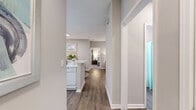 Located in Atlanta, GA, this single-floor, 2-bedroom, 2-bathroom residence offers a practical and comfortable layout with modern finishes throughout. The open-concept living and dining area is anchored by warm hardwood-style flooring and neutral tones, creating a bright, welcoming atmosphere. A distinctive architectural column adds character to the living room, which benefits from natural light streaming through large windows. The dining area sits adjacent to the kitchen and features a pass-through window that enhances connectivity between spaces. The kitchen is outfitted with ample white cabinetry, white appliances, tile backsplash, and generous counter space. Both bathrooms include tub-shower combinations with hardwood-style flooring for easy maintenance. The primary bedroom is a spacious retreat with plush carpeting, dual windows, and room for a full bedroom suite. The second bedroom, also carpeted and naturally lit, offers flexibility as a guest room or additional living space. A central hallway with two closets provides practical storage. The overall aesthetic throughout is clean and contemporary, with consistent neutral tones and cohesive design elements that make the space feel polished and move-in ready.