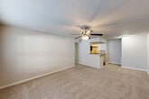 Located in Tomball, TX, this 2-bedroom, 2-bathroom residence offers a functional single-story layout thoughtfully designed for comfortable everyday living. The open-concept living room and kitchen area serves as the heart of the home, with plush wall-to-wall carpeting, neutral tones, and a ceiling fan with light kit providing a welcoming atmosphere. A window at the front allows natural light to fill the space. The kitchen is well-appointed with white shaker-style cabinetry, granite countertops, a stainless steel sink, and a full suite of stainless steel appliances including a range, microwave, refrigerator, and dishwasher. Wood-look flooring runs through the kitchen, adding warmth and easy maintenance. The primary bedroom is generously sized, featuring carpet flooring, a ceiling fan, and a window with outdoor views. The second bedroom is equally comfortable, also carpeted and equipped with a ceiling fan. A dedicated closet provides additional storage. Both bathrooms are appointed with tub/shower combinations finished in elegant marble-look wall surrounds with brushed nickel fixtures, lending a polished feel. The textured ceilings and clean white trim are consistent throughout, creating a cohesive and well-maintained interior.