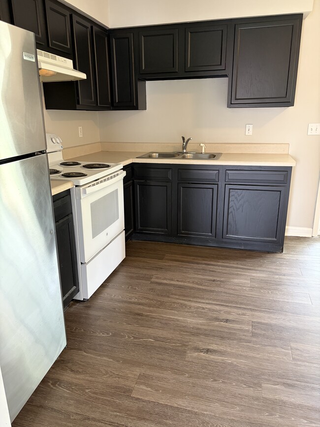 Large kitchen with new fridge and freshly painted cabinets - 3122 Brickdale Ln