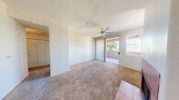 Located in Phoenix, AZ, this one-bedroom, one-bathroom residence offers a well-organized single-floor layout designed for comfortable everyday living. The open-concept living area is anchored by a tile-surround fireplace and features plush carpeting, neutral walls, and a ceiling fan. A large window with vertical blinds allows natural light to fill the space, while a sliding glass door provides direct access to a private balcony with views of surrounding greenery.

The kitchen is efficiently designed with warm wood cabinetry, laminate countertops, tile flooring, and black appliances including a refrigerator, range, microwave, and dishwasher. A raised breakfast bar peninsula connects the kitchen to the living and dining area, making it ideal for casual dining or entertaining.

The bedroom is a well-proportioned retreat featuring soft carpeting, a ceiling fan with light fixture, and a window that brings in natural light. A dedicated closet provides convenient storage. The bathroom includes a single-sink vanity with wood cabinetry, a full tub-shower combination, tile flooring, and a large mirror. A hallway connects the main living spaces, completing this practical and comfortable floor plan.