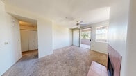 Located in Phoenix, AZ, this one-bedroom, one-bathroom residence offers a well-organized single-floor layout designed for comfortable everyday living. The open-concept living area is anchored by a tile-surround fireplace and features plush carpeting, neutral walls, and a ceiling fan. A large window with vertical blinds allows natural light to fill the space, while a sliding glass door provides direct access to a private balcony with views of surrounding greenery.

The kitchen is efficiently designed with warm wood cabinetry, laminate countertops, tile flooring, and black appliances including a refrigerator, range, microwave, and dishwasher. A raised breakfast bar peninsula connects the kitchen to the living and dining area, making it ideal for casual dining or entertaining.

The bedroom is a well-proportioned retreat featuring soft carpeting, a ceiling fan with light fixture, and a window that brings in natural light. A dedicated closet provides convenient storage. The bathroom includes a single-sink vanity with wood cabinetry, a full tub-shower combination, tile flooring, and a large mirror. A hallway connects the main living spaces, completing this practical and comfortable floor plan.