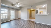 Located at 2302 E William Cannon Dr in Austin, TX, this well-appointed 2-bedroom, 2-bathroom residence offers a practical and comfortable single-floor layout. The open living and dining area is finished with durable wood-look flooring and features a ceiling fan, creating a bright and airy atmosphere. A door leads out to a private exterior access point, and windows allow natural light to fill the space with neighborhood views.

The kitchen is efficiently designed with ample gray cabinetry, white countertops, tile flooring, a full suite of appliances including an electric range, dishwasher, and refrigerator, along with a pendant light that adds a finishing touch. A dedicated dining nook adjacent to the kitchen offers additional functionality.

Both bedrooms are generously sized with wood-look flooring, ceiling fans, and large windows that invite natural light. The primary bedroom is notably spacious and includes access to a well-sized closet. The two bathrooms are finished with tile flooring and feature gray vanity cabinetry with white countertops, along with tub-shower combinations. A dedicated in-unit laundry room with a full-size washer and dryer adds everyday convenience. Three closets throughout the unit provide ample storage throughout this thoughtfully laid-out residence.
