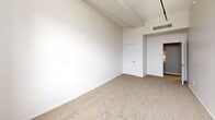 This well-designed 1200 square foot apartment, located at 165 Water Street in Rochester, NY, offers a harmonious blend of space and functionality. The property boasts three bedrooms, including a generous 240 square foot primary bedroom, and one bathroom. The single-floor layout is thoughtfully arranged, featuring a hallway that connects the living spaces.

The apartment's interior is characterized by a clean, contemporary aesthetic. Walls are painted in a crisp white, creating a bright and airy atmosphere throughout. The flooring alternates between plush carpeting in the bedrooms and living areas, and practical wood-look flooring in the bathroom, adding warmth and texture to the space.

Large windows in the bedrooms and living area allow ample natural light to flood the rooms, while also offering views of the surrounding urban landscape. The bathroom is outfitted with modern fixtures, including a combination bathtub and shower enclosed in white tiling.

A standout feature is the track lighting system installed in the main living area, providing flexible illumination options. The apartment also includes built-in closets in the bedrooms and hallway, maximizing storage space.

The property's location in downtown Rochester (zip code 14604) places residents in the heart of the city, likely within easy reach of amenities and attractions. This apartment would appeal to those seeking a contemporary urban living experience with a practical and efficient use of space.
