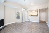 Located at 888 Davis St in San Leandro, CA, this 2-bedroom, 3-bathroom residence offers a thoughtfully designed single-floor layout with a comfortable and functional living experience. The open-concept living and dining area is anchored by a fireplace and features light wood-tone flooring, neutral-toned walls, and large windows that invite abundant natural light. A sliding glass door leads to a private balcony, extending the living space outdoors.

The kitchen is well-appointed with white shaker cabinetry, granite countertops, stainless steel appliances including a gas range, dishwasher, and refrigerator, complemented by a gold-finish sink faucet. A peninsula with a granite counter provides a natural divider between the kitchen and the adjacent living area.

Both bedrooms are carpeted and feature neutral walls, natural light from windows with blinds, and generous closet space — four closets in total serve the unit. The primary bedroom offers a comfortable footprint with its own dedicated closet.

The three bathrooms are finished with wood-look vinyl flooring and clean, minimalist fixtures including tub/shower combinations and brushed nickel hardware. A hallway connects all areas efficiently, and the entrance provides a welcoming transition into the home. Four closets throughout offer practical storage solutions.