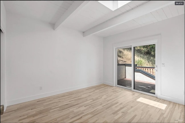 One bedroom opens onto deck and has sky light with retractable blind. - 300 Miller Ave