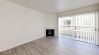 Located at 1250 N June St in the heart of Los Angeles, CA 90038, this one-bedroom, one-bathroom unit offers a well-organized, efficiently designed layout across a single floor. The living room serves as the central gathering space, featuring light-toned hardwood-style flooring, crisp white walls, and a tile-surround fireplace that anchors the room. Sliding glass doors with vertical blinds open directly to a private balcony, filling the space with natural light and providing an outdoor retreat. The bedroom is a comfortable, quiet space with the same wood-style flooring, clean white walls, and a horizontal clerestory window that allows in additional natural light while maintaining privacy. A dedicated closet provides practical storage. The bathroom is finished with light tile flooring, a tub-shower combination with marble-style tile surround, a white vanity with a framed mirror, and neutral countertops — all contributing to a clean, functional aesthetic. Throughout the unit, the consistent use of neutral tones, modern finishes, and light flooring creates a cohesive and inviting ambiance. The layout makes efficient use of the available space, offering all the essential amenities in a well-appointed, move-in-ready setting in a prime Los Angeles location.